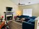 Comfortable living room with a fireplace, large sectional sofa, and a ceiling fan at 5814 Highgrove Dr, Atlanta, GA 30349
