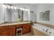 Bright bathroom featuring double vanity with granite counters and a luxurious soaking tub at 1227 Parkside Village Nw Dr, Marietta, GA 30060