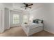 Bright bedroom with a tray ceiling, ceiling fan, and large window at 1227 Parkside Village Nw Dr, Marietta, GA 30060