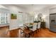 Open floor plan featuring modern dining room with stainless steel fridge and bright lighting at 1227 Parkside Village Nw Dr, Marietta, GA 30060