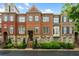 Beautiful brick townhome featuring stone accents, shutters, and manicured landscaping at 1227 Parkside Village Nw Dr, Marietta, GA 30060