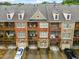 Townhome exterior featuring brick facade, private balconies, and attached garages at 1227 Parkside Village Nw Dr, Marietta, GA 30060