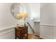 Elegant hallway with a decorative mirror, dark wood chest, and hardwood floors at 1227 Parkside Village Nw Dr, Marietta, GA 30060