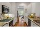 Galley kitchen with granite counters, stainless appliances, and eat-in area at 1227 Parkside Village Nw Dr, Marietta, GA 30060