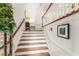 Bright foyer staircase with white risers, wood treads, and white railings at 1227 Parkside Village Nw Dr, Marietta, GA 30060