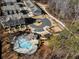 Aerial view of the community with a pool, dog park, pavilion, walking path, and townhomes at 124 Everley Walk, Alpharetta, GA 30009