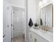 A bright bathroom features a single vanity, modern fixtures, and a bath tub at 124 Everley Walk, Alpharetta, GA 30009