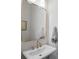 Bathroom featuring a pedestal sink, gold faucet and a large mirror at 124 Everley Walk, Alpharetta, GA 30009
