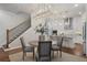 Elegant dining area with modern lighting and a view into the stylish kitchen at 124 Everley Walk, Alpharetta, GA 30009
