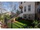 Charming townhouse with a well-kept lawn, brick stairs, and black wrought iron fence at 124 Everley Walk, Alpharetta, GA 30009