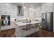Bright eat-in kitchen with an island, stainless appliances and lots of white cabinets at 124 Everley Walk, Alpharetta, GA 30009