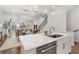 Open concept kitchen, living room and dining space with hardwood floors and modern lighting at 124 Everley Walk, Alpharetta, GA 30009