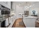 Bright eat-in kitchen with an island, stainless appliances and lots of white cabinets at 124 Everley Walk, Alpharetta, GA 30009