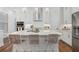 Bright eat-in kitchen with an island, stainless appliances and lots of white cabinets at 124 Everley Walk, Alpharetta, GA 30009