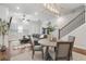 Open concept living room with hardwood floors, modern lighting, and a staircase at 124 Everley Walk, Alpharetta, GA 30009