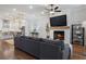 Open-concept living space with a fireplace, hardwood floors, and views into the dining and kitchen areas at 124 Everley Walk, Alpharetta, GA 30009