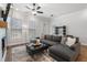 Inviting living room with a large sectional sofa, fireplace, and ample natural light at 124 Everley Walk, Alpharetta, GA 30009
