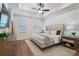 A beautifully decorated main bedroom features a tufted headboard and stylish decor at 124 Everley Walk, Alpharetta, GA 30009