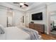 Well-lit main bedroom with hardwood floors, a ceiling fan, and neutral decor at 124 Everley Walk, Alpharetta, GA 30009