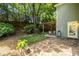 Beautiful fenced backyard featuring a lush lawn, stone patio, and charming pergola dining area at 1100 Ashbury Dr, Decatur, GA 30030