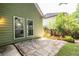 Private backyard featuring stone patio, raised garden beds, and lush green lawn at 1100 Ashbury Dr, Decatur, GA 30030