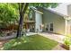 Beautiful fenced backyard featuring a lush lawn, stone patio, and charming pergola dining area at 1100 Ashbury Dr, Decatur, GA 30030