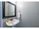 Bathroom featuring a white sink, a black framed mirror, and light blue painted walls at 1100 Ashbury Dr, Decatur, GA 30030