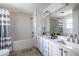 Bright bathroom with double sinks, a shower-tub combo, and updated tile at 1100 Ashbury Dr, Decatur, GA 30030