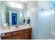 Bright bathroom featuring a modern vanity, large mirror, and shower-tub combination at 1100 Ashbury Dr, Decatur, GA 30030
