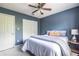 Blue bedroom featuring a ceiling fan, large closet, and modern decor at 1100 Ashbury Dr, Decatur, GA 30030