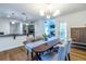Open dining area features decorative lighting and wood floors with an open view to the kitchen and living room at 1100 Ashbury Dr, Decatur, GA 30030