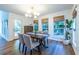 The dining room features three windows and hardwood floors with a view to the wooded property at 1100 Ashbury Dr, Decatur, GA 30030