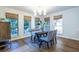 Bright dining room with three windows, hardwood floors and a wooden storage cabinet at 1100 Ashbury Dr, Decatur, GA 30030