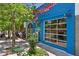 Exterior view of a vibrant blue restaurant with large windows and a cozy outdoor seating area at 1100 Ashbury Dr, Decatur, GA 30030