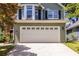 Two-story home featuring an attached two-car garage and a concrete driveway at 1100 Ashbury Dr, Decatur, GA 30030