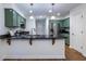 Kitchen featuring custom green cabinets, stainless steel refrigerator, and granite countertops at 1100 Ashbury Dr, Decatur, GA 30030