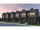 Charming new townhomes with brick facade, large windows, and professional landscaping on a tree-lined street at 1348 Grannysmith Trce # 39, Brookhaven, GA 30319