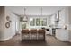 Well-lit kitchen featuring stainless appliances, white cabinets, a breakfast bar with pendant lighting, and wood flooring at 1348 Grannysmith Trce # 39, Brookhaven, GA 30319