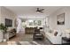 Bright open-plan living room flowing into a modern kitchen, featuring hardwood floors, a ceiling fan, and recessed lighting at 1348 Grannysmith Trce # 39, Brookhaven, GA 30319