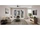 Bright open-plan living room with a ceiling fan and recessed lighting, featuring large sliding glass doors at 1348 Grannysmith Trce # 39, Brookhaven, GA 30319