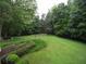 Expansive backyard featuring a dormant pool surrounded by lush greenery at 1811 Murdock Rd, Marietta, GA 30062