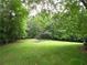 Large, lush backyard with mature trees and open green space, offering privacy and a natural setting at 1811 Murdock Rd, Marietta, GA 30062