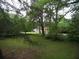 Large backyard featuring mature trees and lush greenery at 1811 Murdock Rd, Marietta, GA 30062