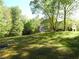 Large backyard with mature trees surrounding a custom home, perfect for recreation at 1811 Murdock Rd, Marietta, GA 30062