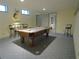 Finished basement with a pool table and adjacent seating area with bar stools at 1811 Murdock Rd, Marietta, GA 30062