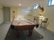 Finished basement with a pool table and adjacent seating area with bar stools at 1811 Murdock Rd, Marietta, GA 30062
