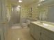 Clean bathroom with a walk-in shower, double sink vanity, and decorative wallpaper at 1811 Murdock Rd, Marietta, GA 30062