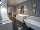 Elegant bathroom featuring classic blue striped wallpaper, clawfoot tub, and double vanity sinks at 1811 Murdock Rd, Marietta, GA 30062