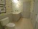 Well-maintained bathroom with yellow wallpaper, a single sink, and tiled floors at 1811 Murdock Rd, Marietta, GA 30062