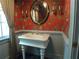 Powder room with pedestal sink, vintage wallpaper, and wainscoting at 1811 Murdock Rd, Marietta, GA 30062